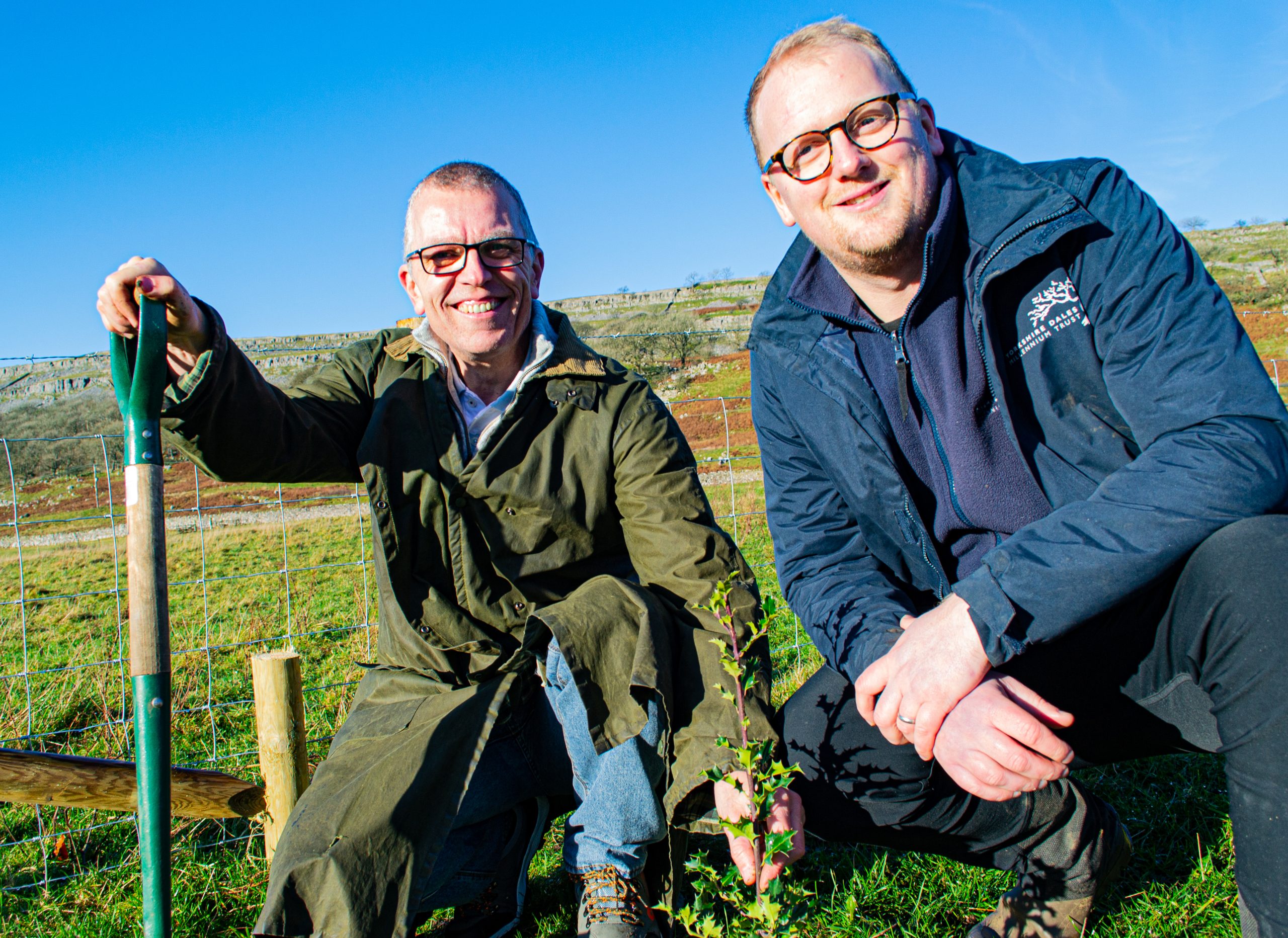 Photo of Greg planting a tree